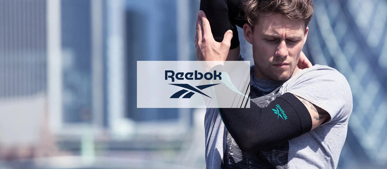 Person with Reebok elbow compression sleeves